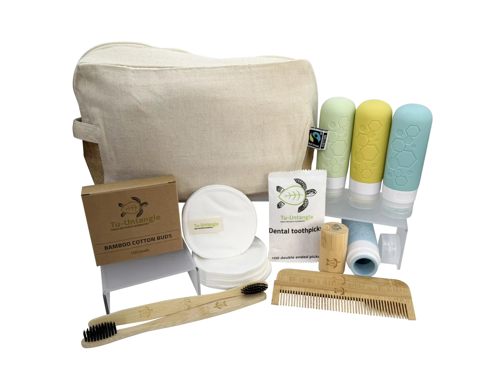 Set of eco-friendly bathroom products including a bag, toothbrush, comb, and dental tools on a white background.