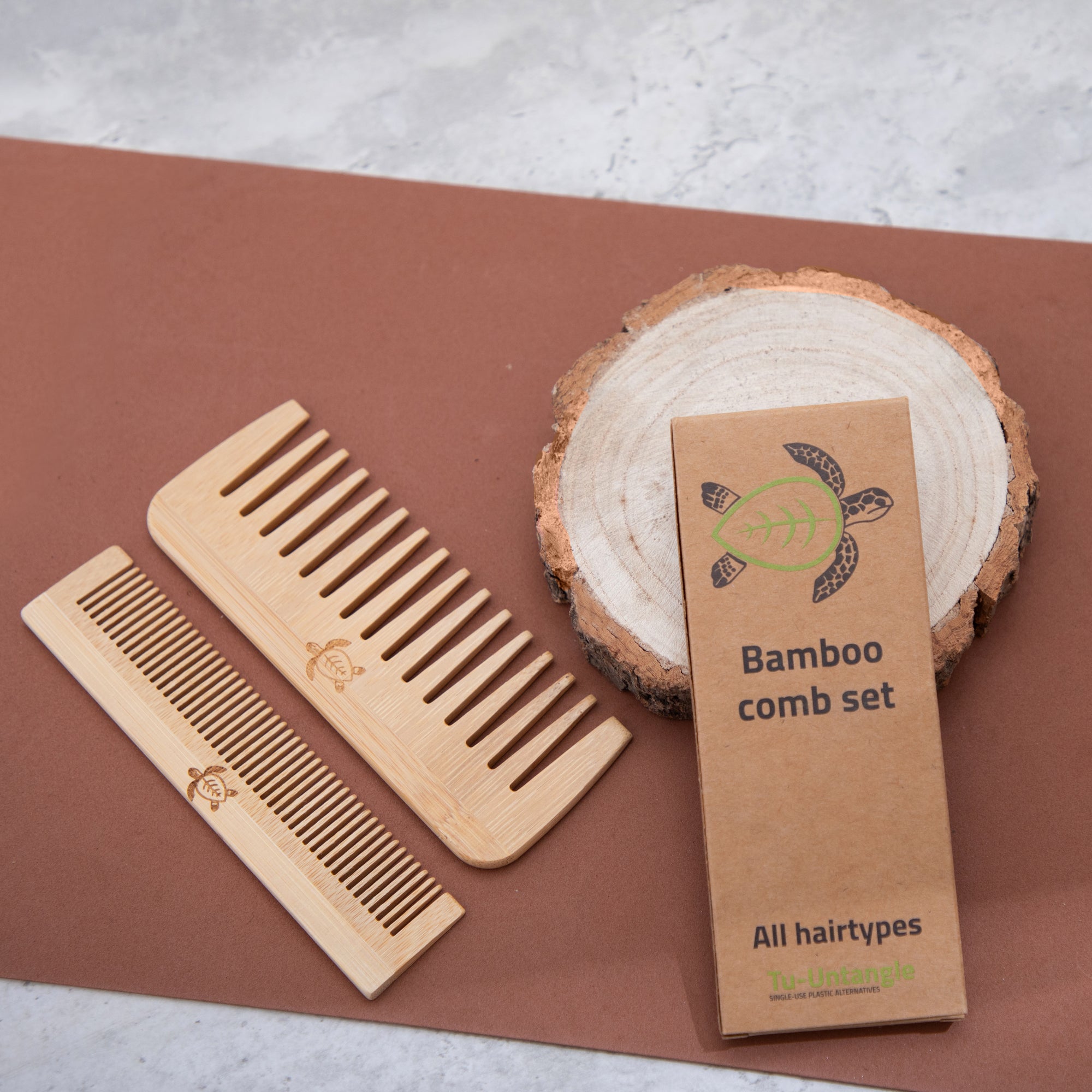 Bamboo comb set with packaging on a wooden surface