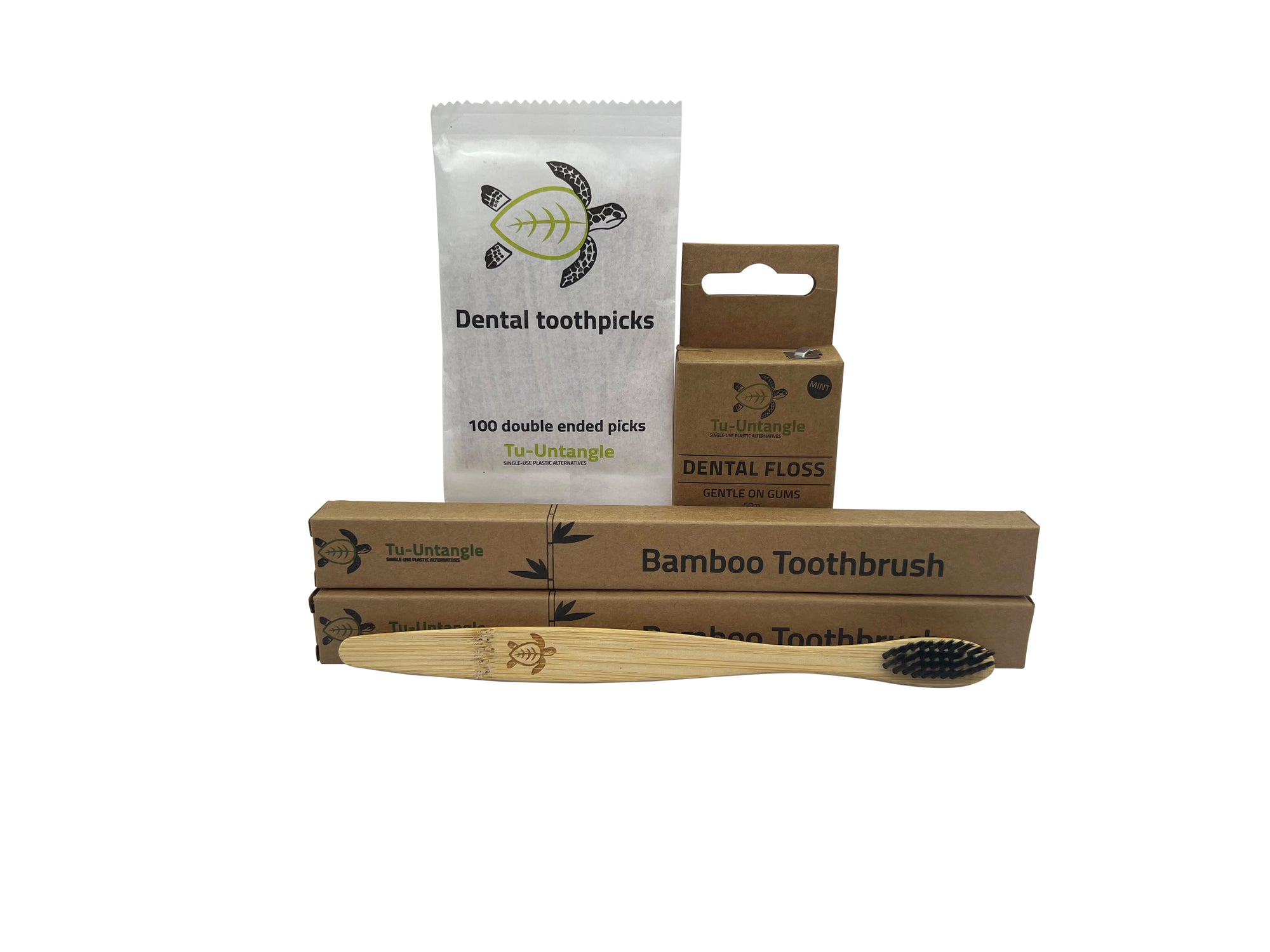 Bamboo toothbrush, dental floss, and toothpicks on a white background
